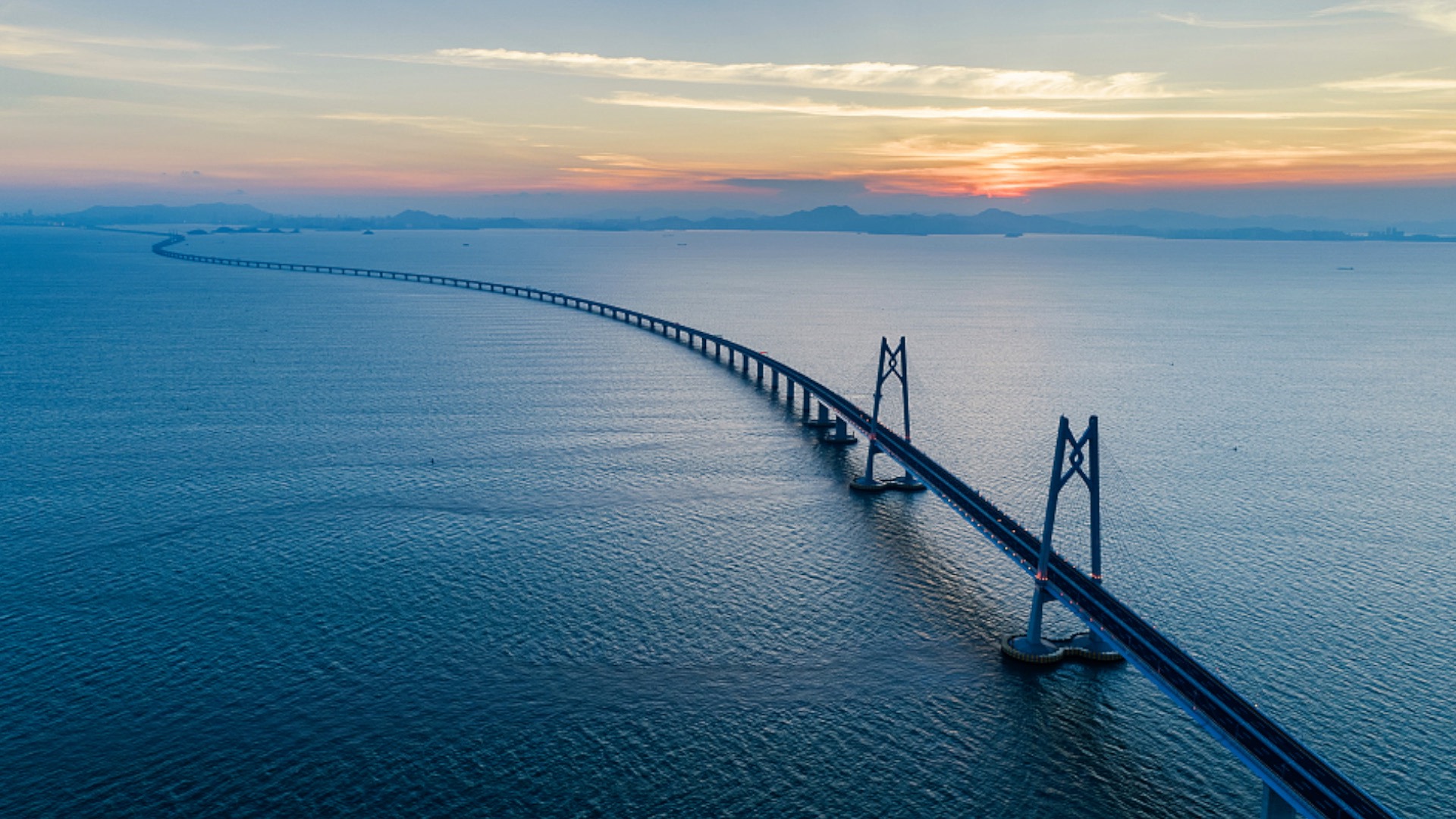 Hong Kong–Zhuhai–Macau Bridge stretching across the sea at sunset