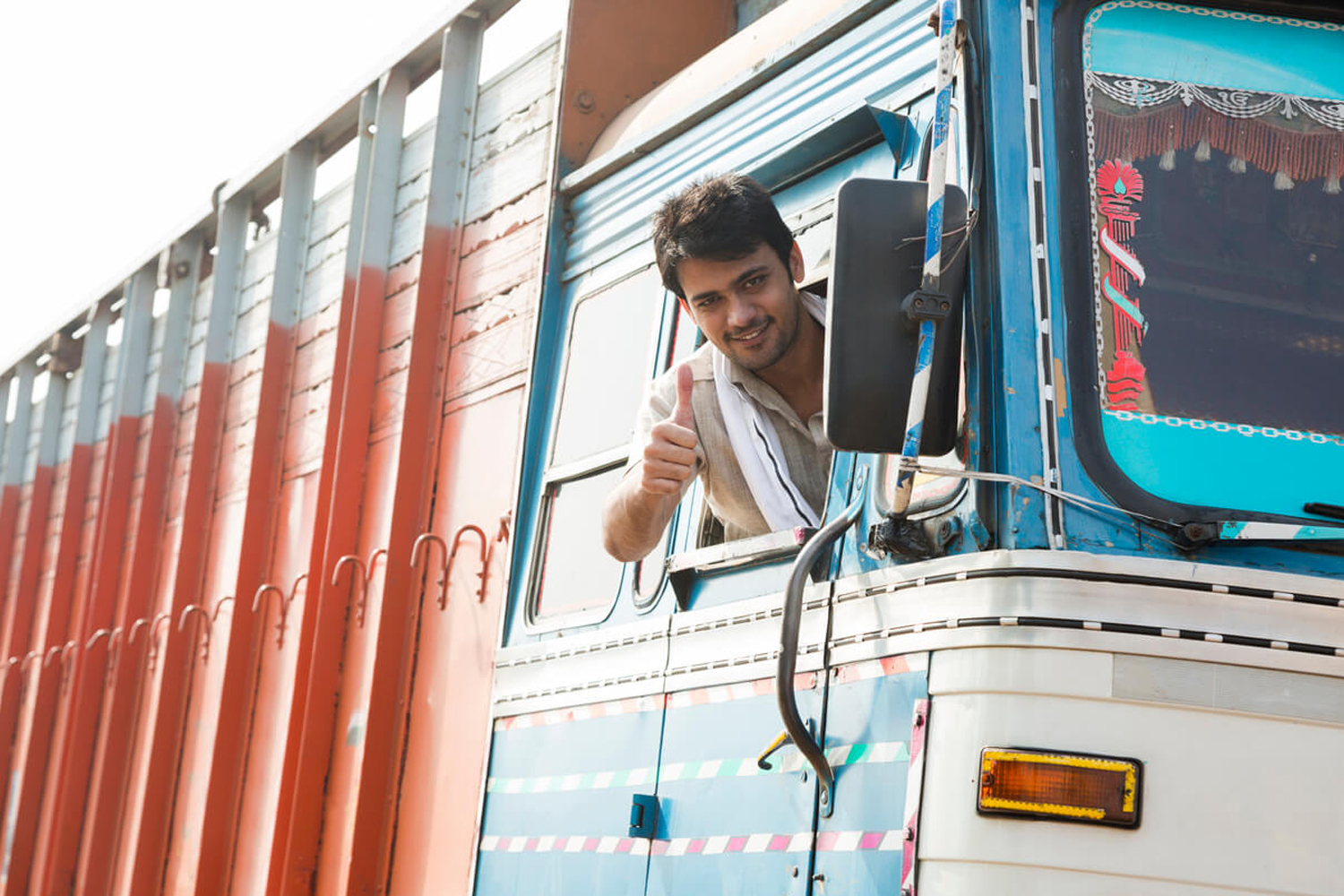 A community transport worker beside his vehicle