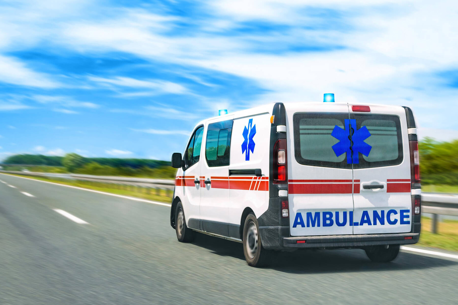 An ambulance travelling along a highway